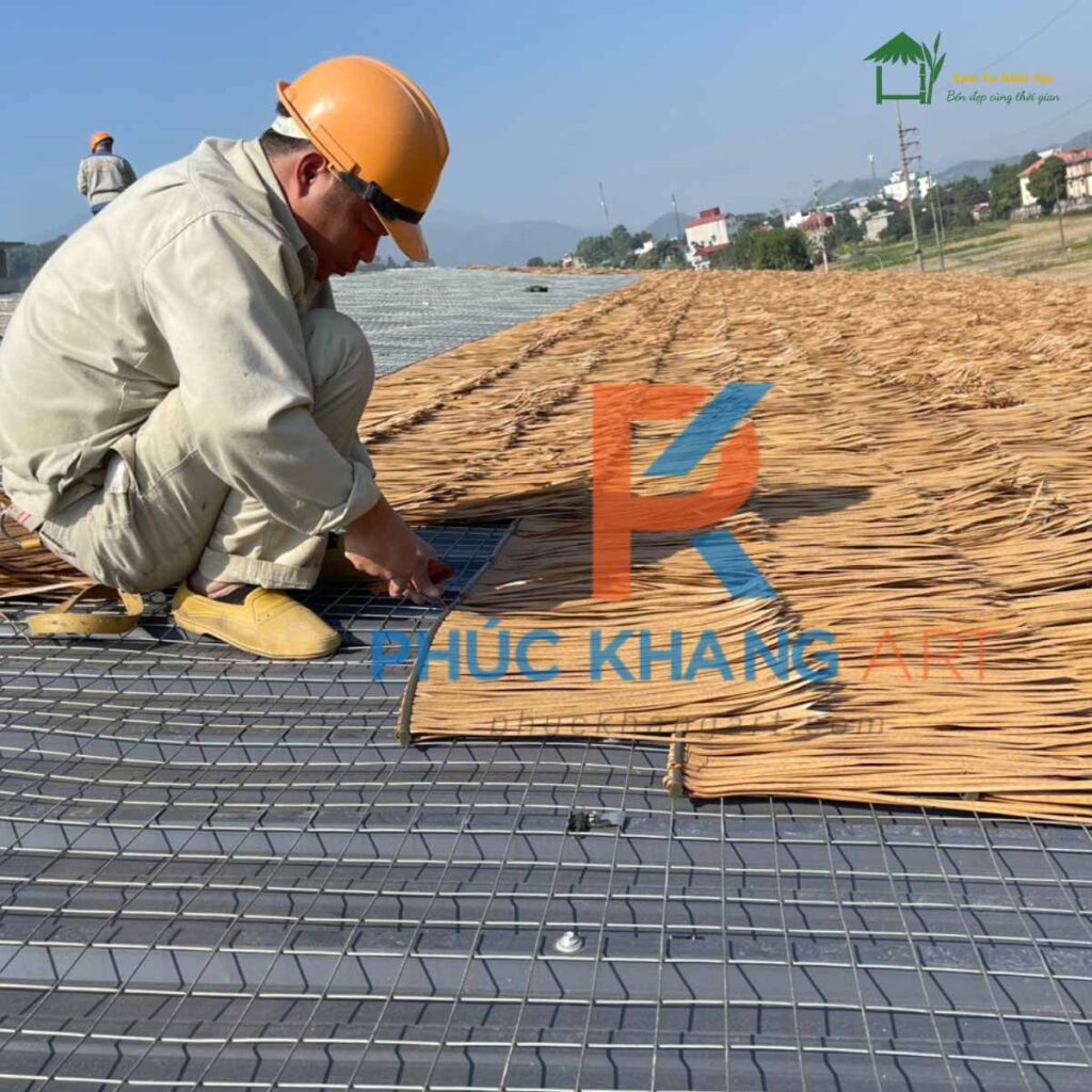 Thợ lợp rơm nhân tạo trên mái tôn
